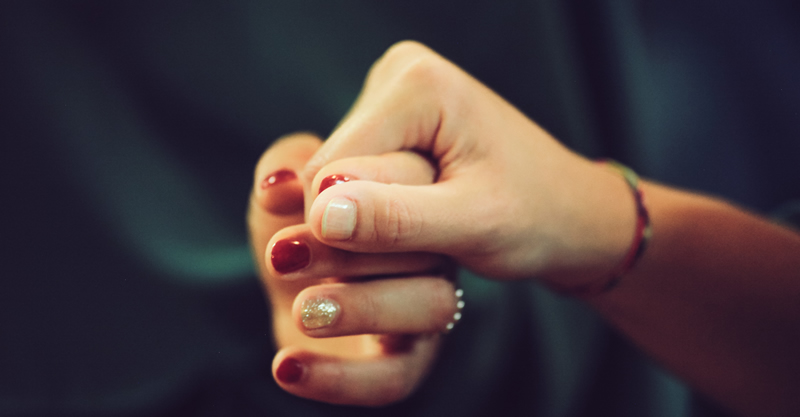 photo of two women holding hands