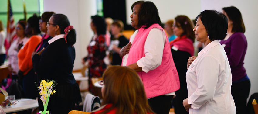 from the 2017 event, a diverse audience of women participate in a question and answer session