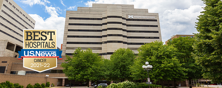 Rogel Cancer Center building in the summer time with US News badge