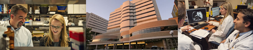 U-M cancer center building, researcher with student and doctors discussing a patient test result