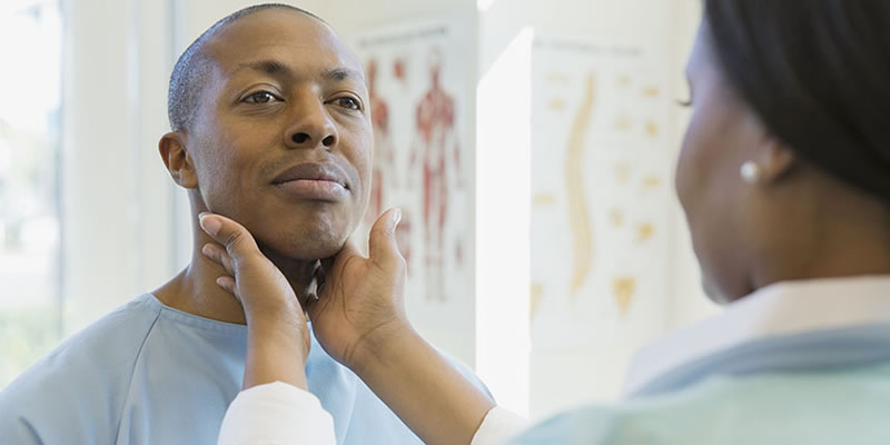 man having  his throat checked for cancer