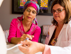 Madge McGinn learns how to use her IV pump from Marie Richards, RN