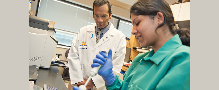 Arul M. Chinnaiyan, M.D., Ph.D. with female lab assistant