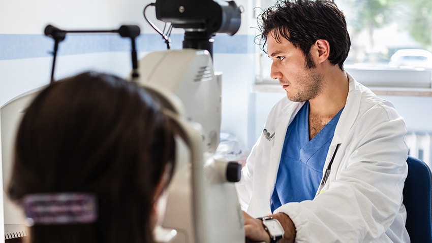 photo of a researcher looking at a scan of a breast cancer tumor