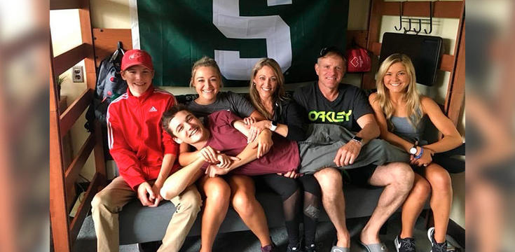 Goff and her three siblings and parents sitting together on a bunk bed while on vacation