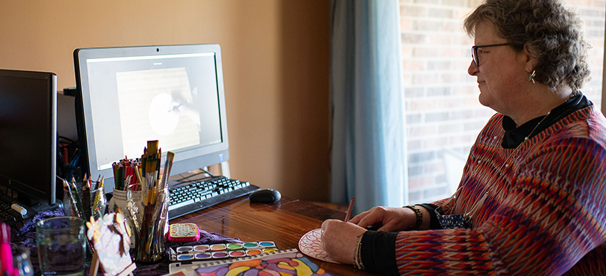 Theresa Gougeon working in front of her computer