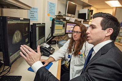 Daniel Spratt, M.D. looks at a prostate scan with a colleague