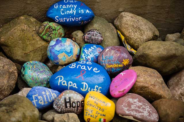 a photo of several rocks painted with words of encouragement