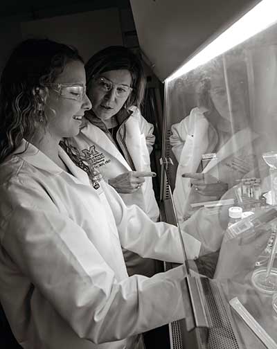 Lawlor with Jennifer Jimenez in the lab