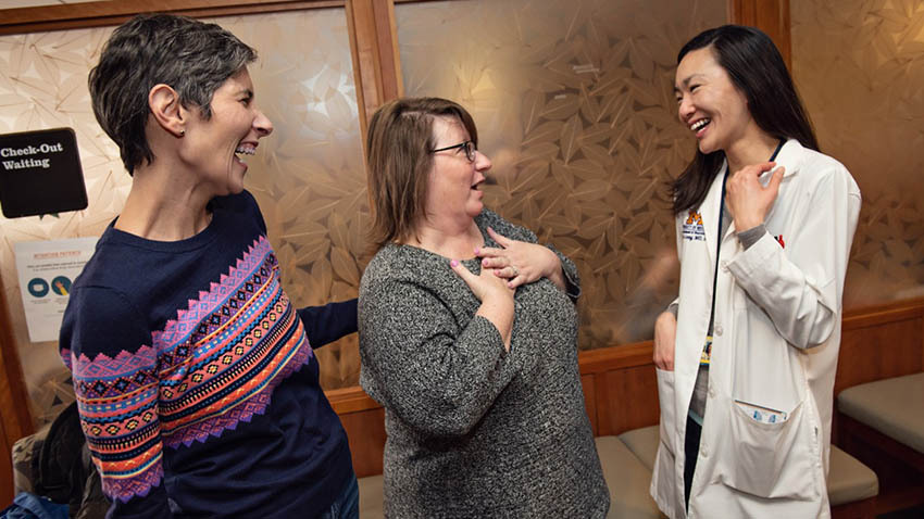 Patients Andrea Passmore and Katie Dorr share a laugh with their neuro-oncologist, Denise Leung, M.D. Photo credit: Leisa Thompson