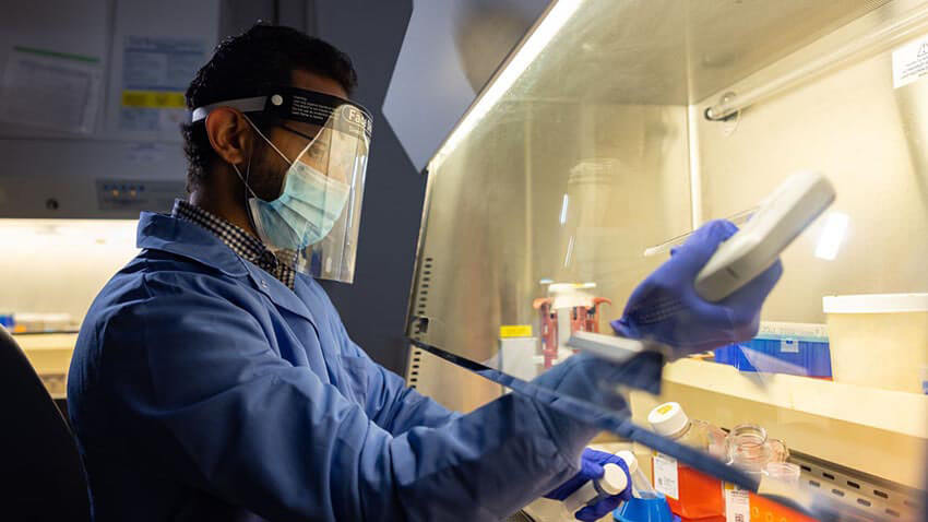 Researcher in science lab pipetting