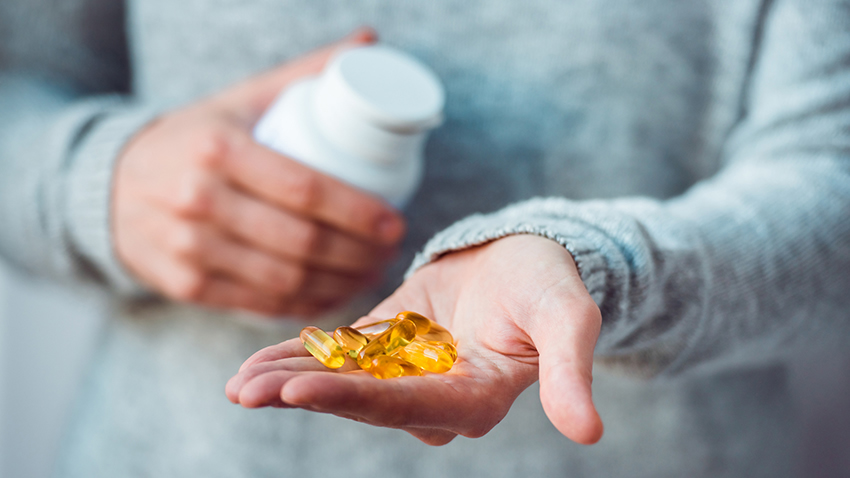 image of doctor holding pills in his hands