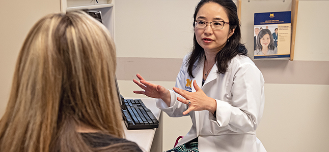 Aki Morikawa, MD talks to a patient