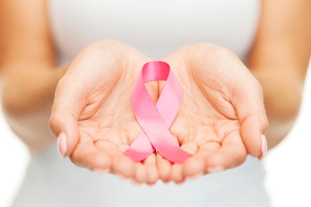 woman holding breast cancer awareness ribbon