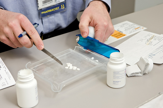 Pharmacist sorting pills