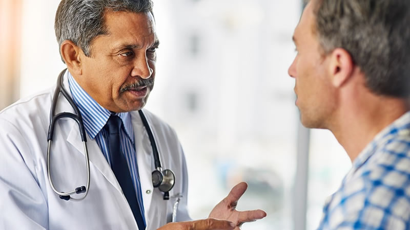 Doctor talking to male patient