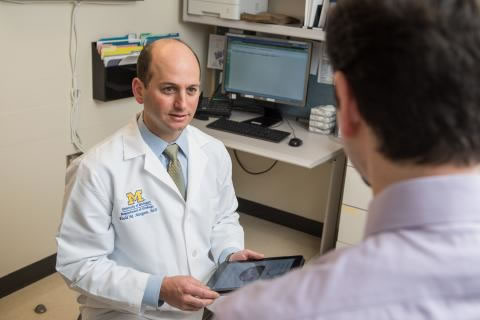 Todd Morgan, MD talks to a patient