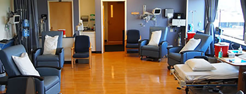 an image of a room with infusion chairs and a window