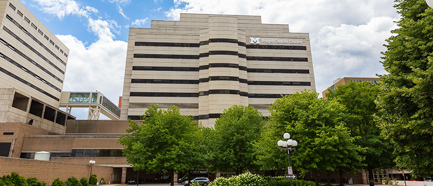 Rogel Cancer Center Building from the front, showing the entrance and blue summer sky