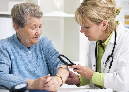 doctor examining patient's skin