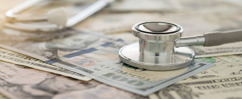 image of stethoscope on top of stack of money