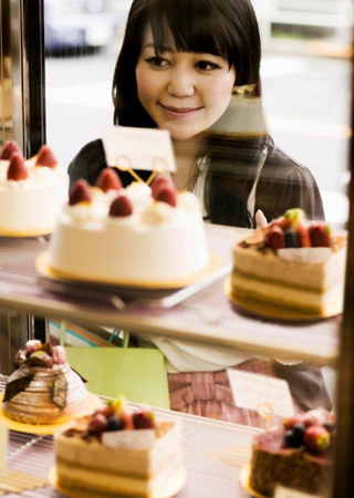 woman looking into candy store