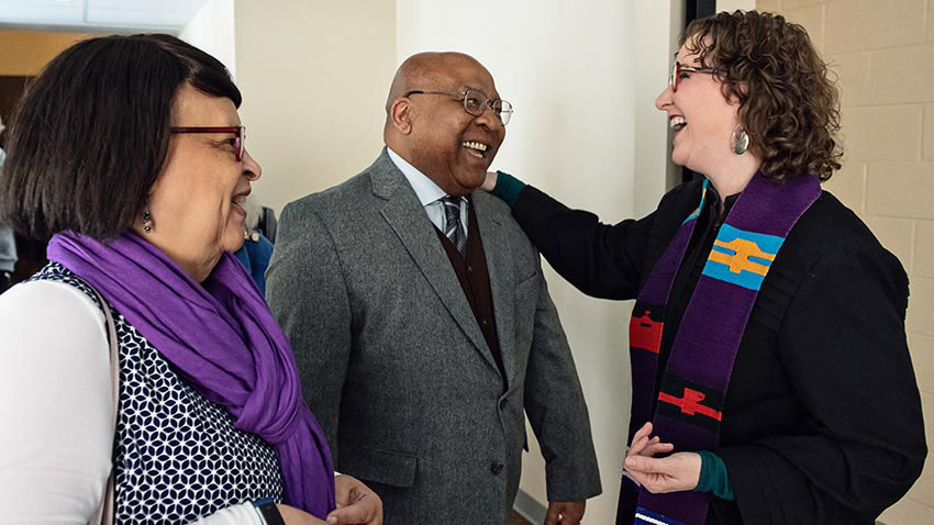 Rev. Duke talks with two parishioners