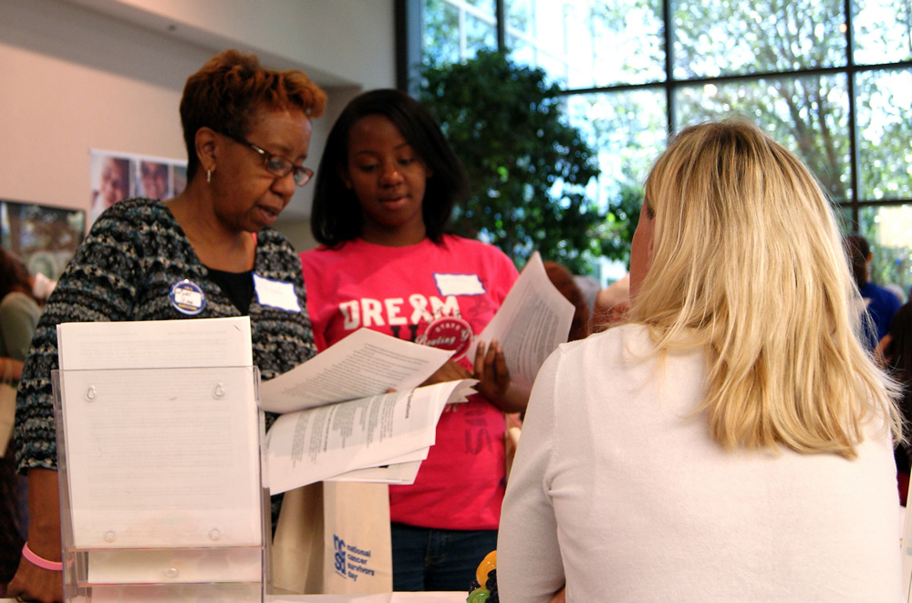Image of two women getting information at a community outreach event