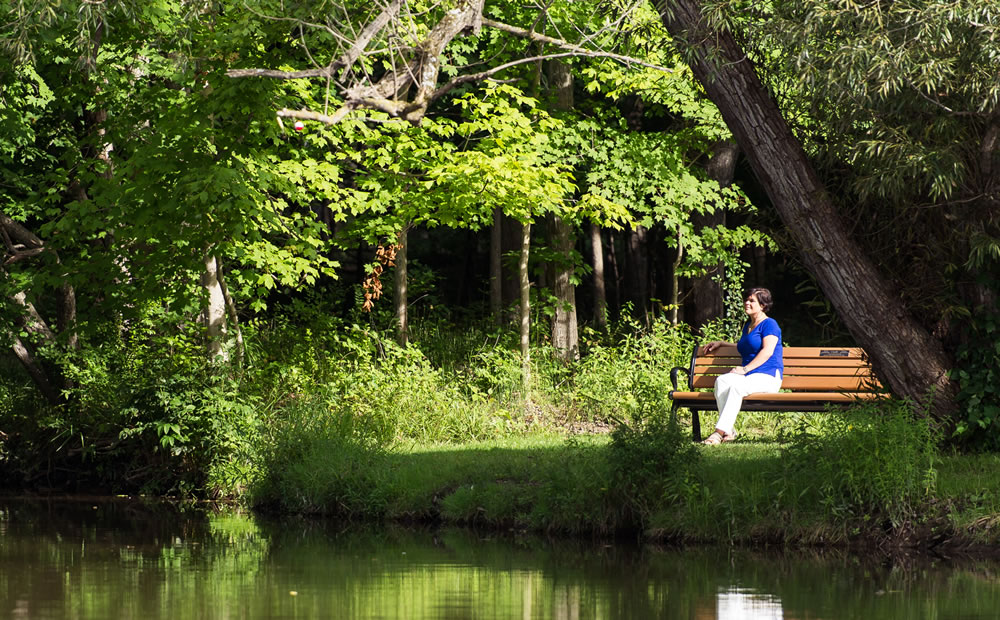 Image of Suzanne Bosek sitting near a lake