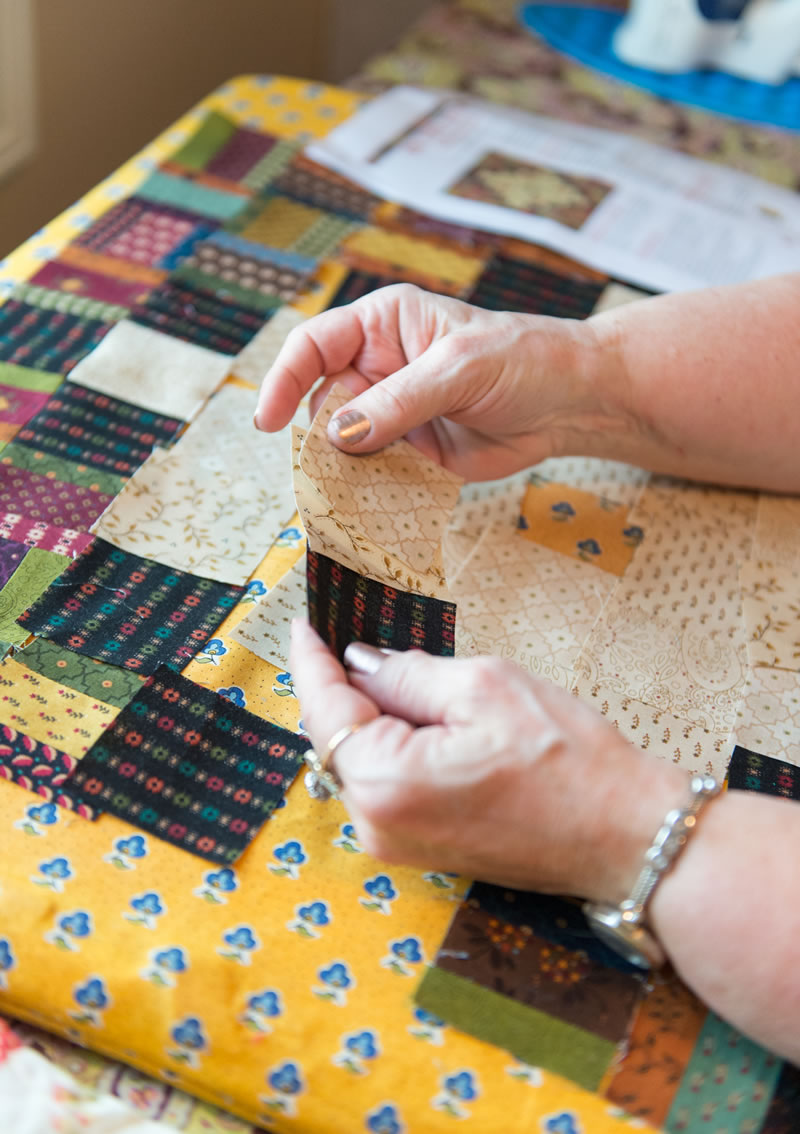 Christine putting pieces of her quilt together