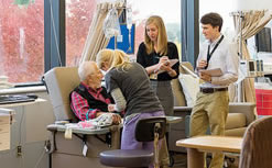 image of industrial engineering students interviewing a patient in the Infusion Center