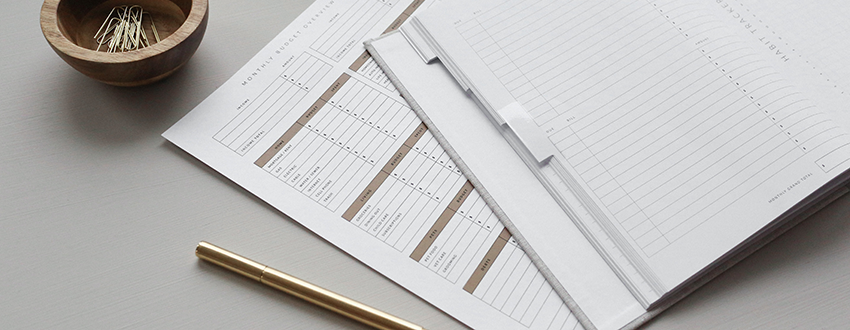 image of spreadsheet and accounting book on a table