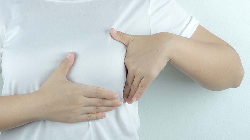 woman doing a breast self exam