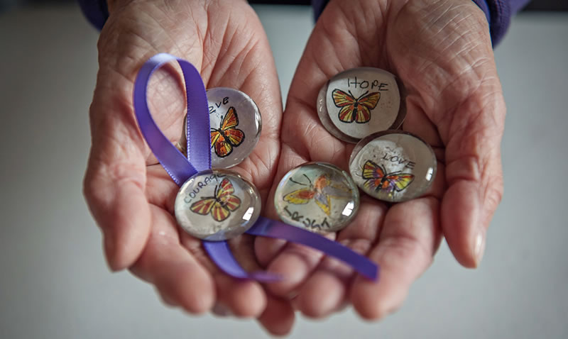 the butterfly stones Worthen makes held in her hands