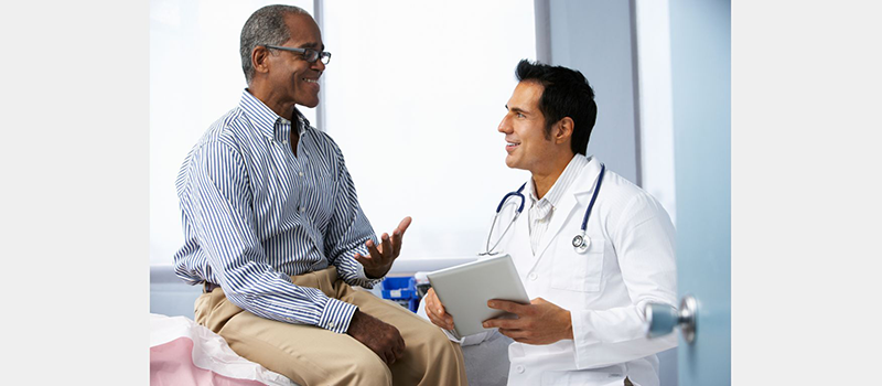 Black male patient talking with a male doctor