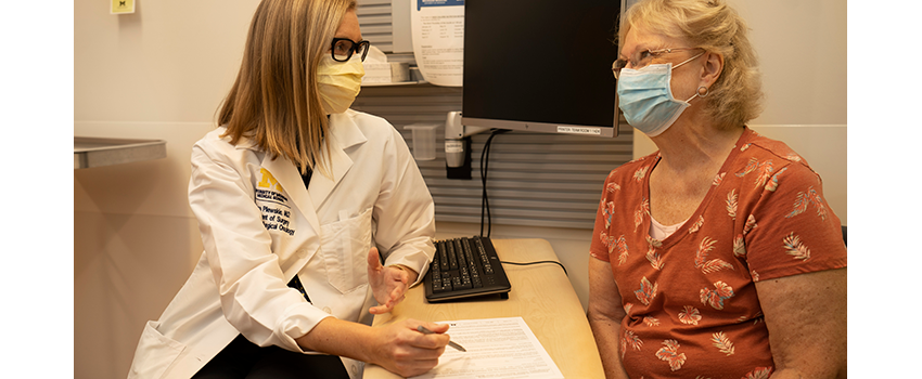 Dr Melissa Pilewskie chatting with a patient during visit to the clinic