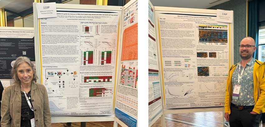 Drs. Sofia Merajver and Nathan Merrill stand before their presentation posters