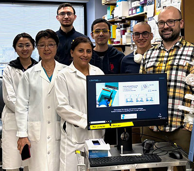 Group of men and women gathered together in the lab