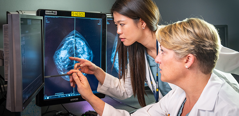 Two female doctors study a mammogram