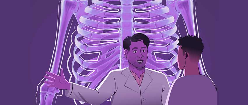 Doctor and patient standing in front of a large chest x-ray