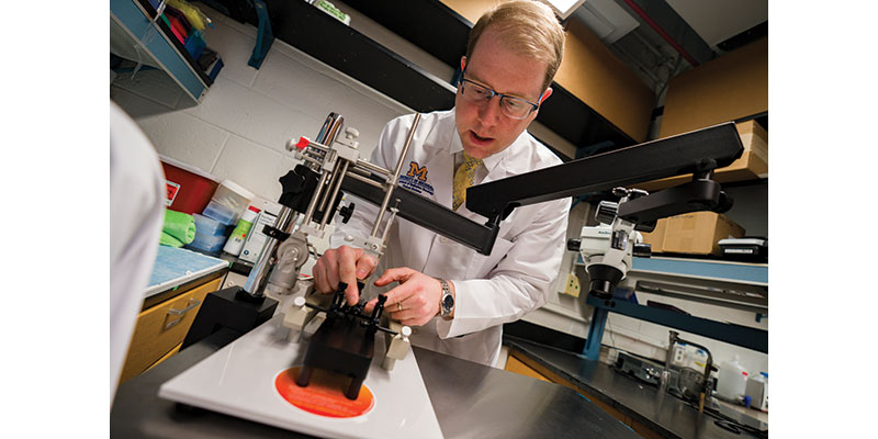 Daniel Wahl is a middle aged white man with glasses working in his lab