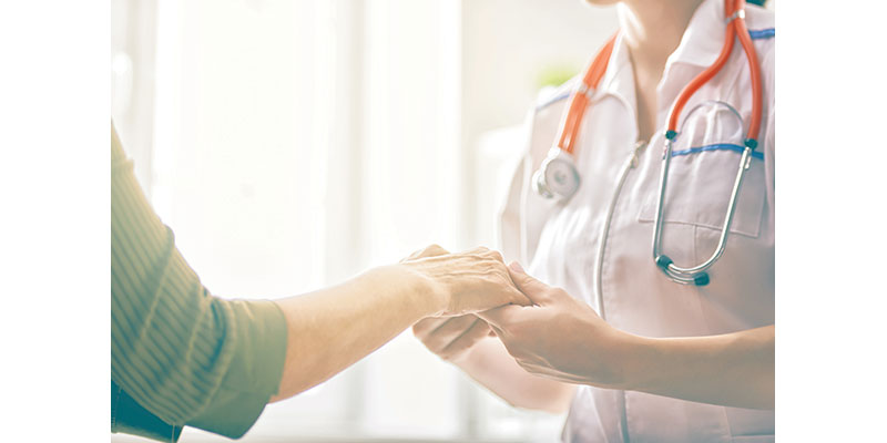 doctor holds the hand of a patient