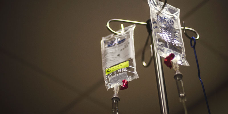 Two chemotherapy iv bags hang from a pole