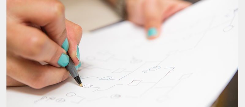 close-up of woman's hand as she works on her family tree