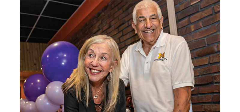 Mr. and Mrs. Rogel signing off on their gift to the cancer center
