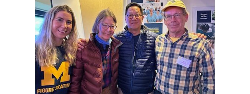 Daughter, mother, President Ono and father stand together in hospital room