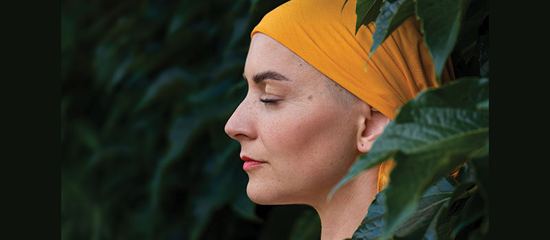 profile of white woman with a colorful turban on her head