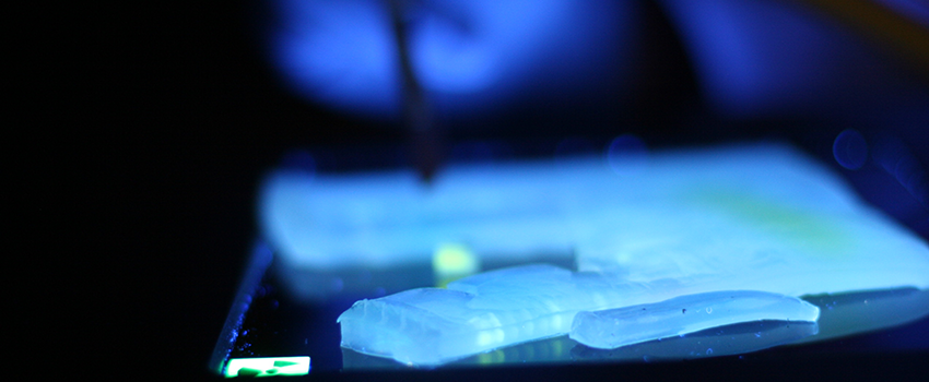 fluorescent blue color lights up a slide under the microscope