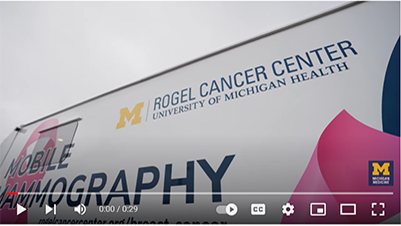 Image of the Mobile Mammography Unit which is a white van with Michigan blue