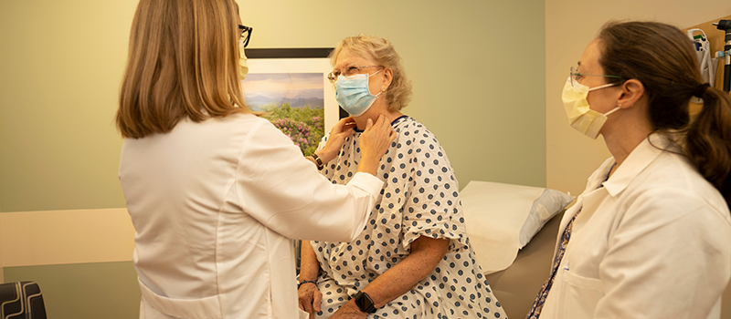 Drs. Melissa Pilewskie and Bess Connors examine a patient